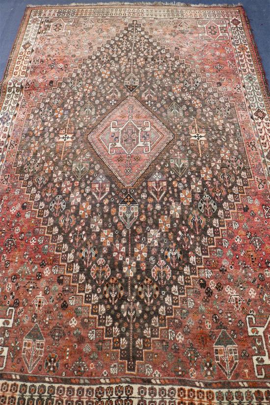 A Persian red and blue ground rug with lozenge-shaped medallion, 261 x 164cm.